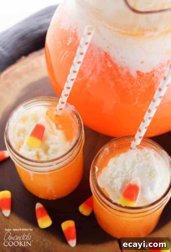 Ghostly Gradient Punch 3 Overhead view of two mason jars showcasing the beautiful layers of Candy Corn Punch