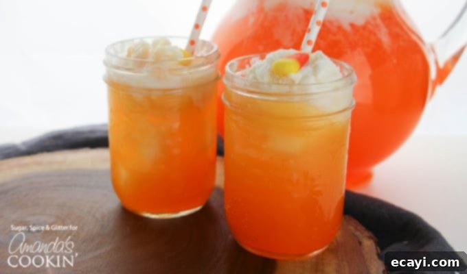 Candy Corn Punch: A festive, non-alcoholic drink for all your fall celebrations Close-up of a beautifully layered Candy Corn Punch in a glass, ready to be enjoyed