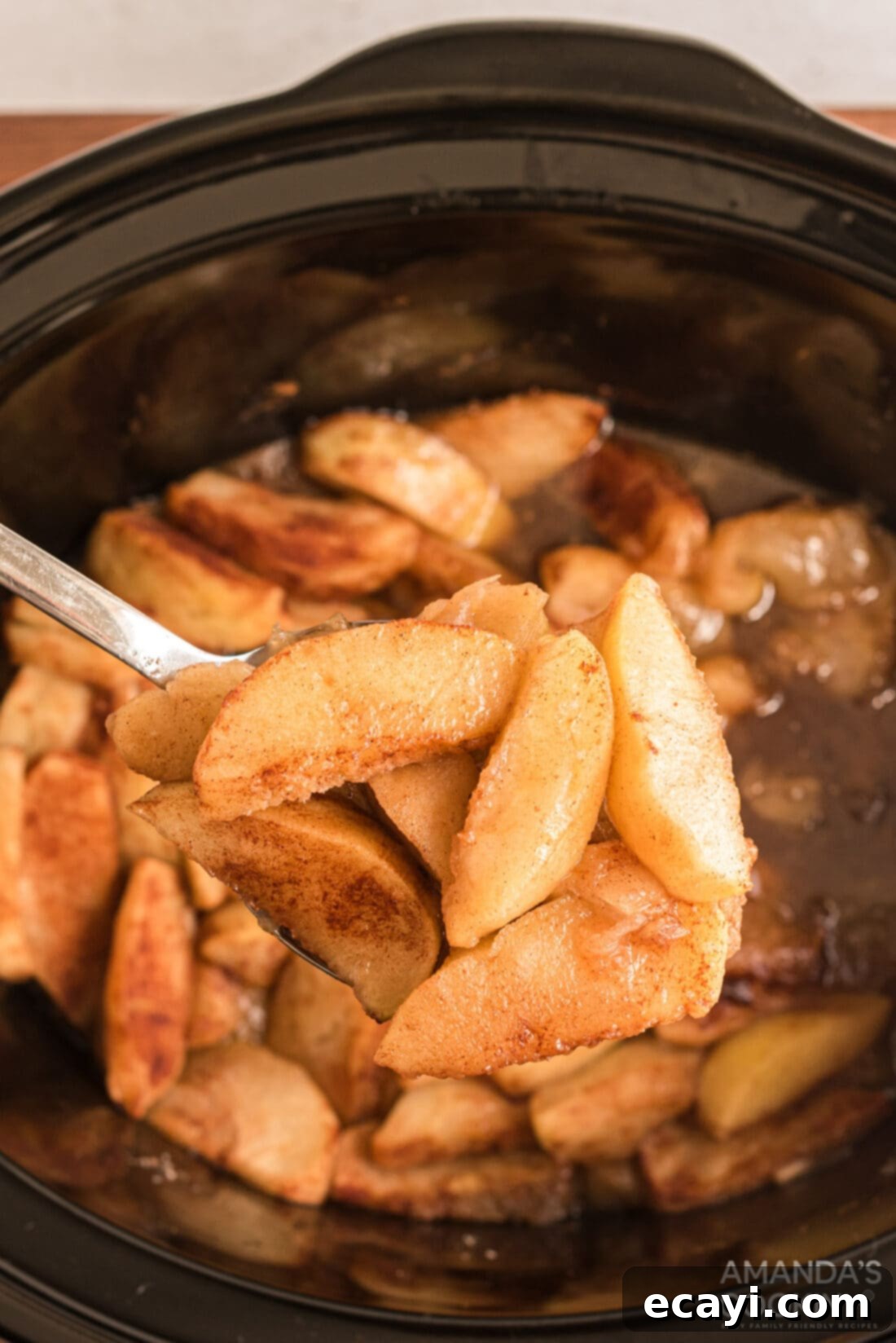 Cozy Slow Cooker Cinnamon Apples 2 spooning out some Crockpot Cinnamon Apples