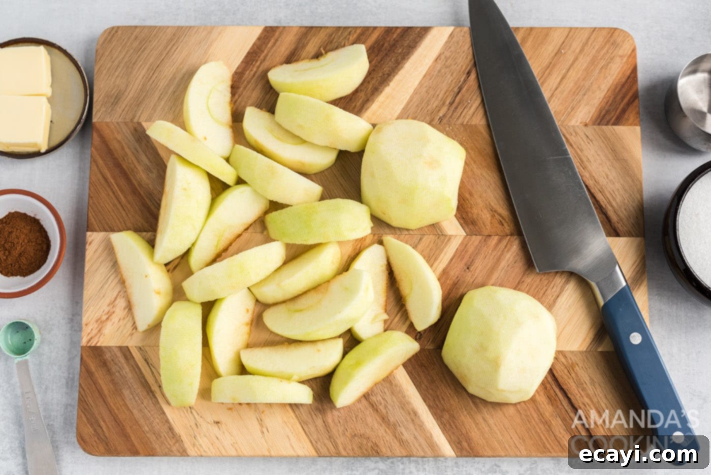 Cozy Slow Cooker Cinnamon Apples 5 sliced granny smith apples on cutting board