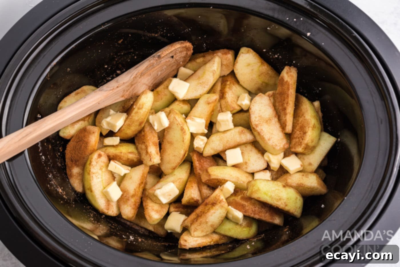 Cozy Slow Cooker Cinnamon Apples 7 butter on top of cinnamon sugar apples