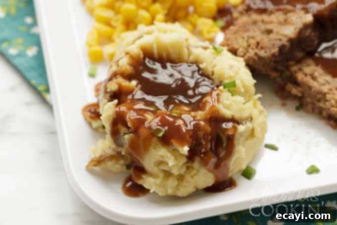 Delicious mashed potatoes, prepared in a slow cooker, offering a smooth and inviting texture for any meal. #mashedpotatoes #slowcookerrecipes #potatorecipes A bowl of freshly mashed potatoes, showing a rich, creamy texture and a sprinkle of fresh parsley, ready to be served as a comforting side.
