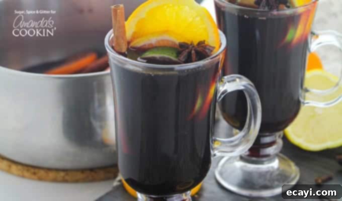 The best classic mulled wine recipe for holidays A beautifully presented classic mulled wine recipe in a clear glass, showing off the rich red color and festive garnishes.