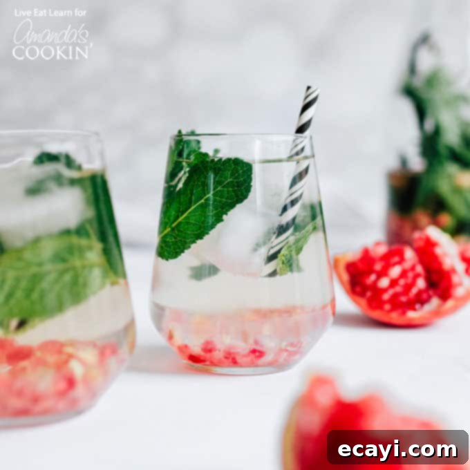 Warm Spiced Wine 3 Refreshing Holiday Detox Drink served in elegant wine glasses with fresh mint and pomegranate seeds