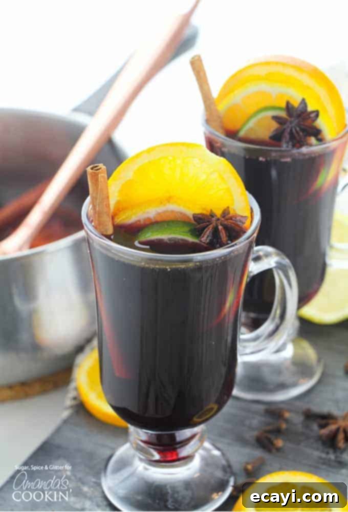 Warm Spiced Wine 6 Large pot of mulled wine simmering on the stove with fresh oranges and spices, creating a warm and inviting atmosphere