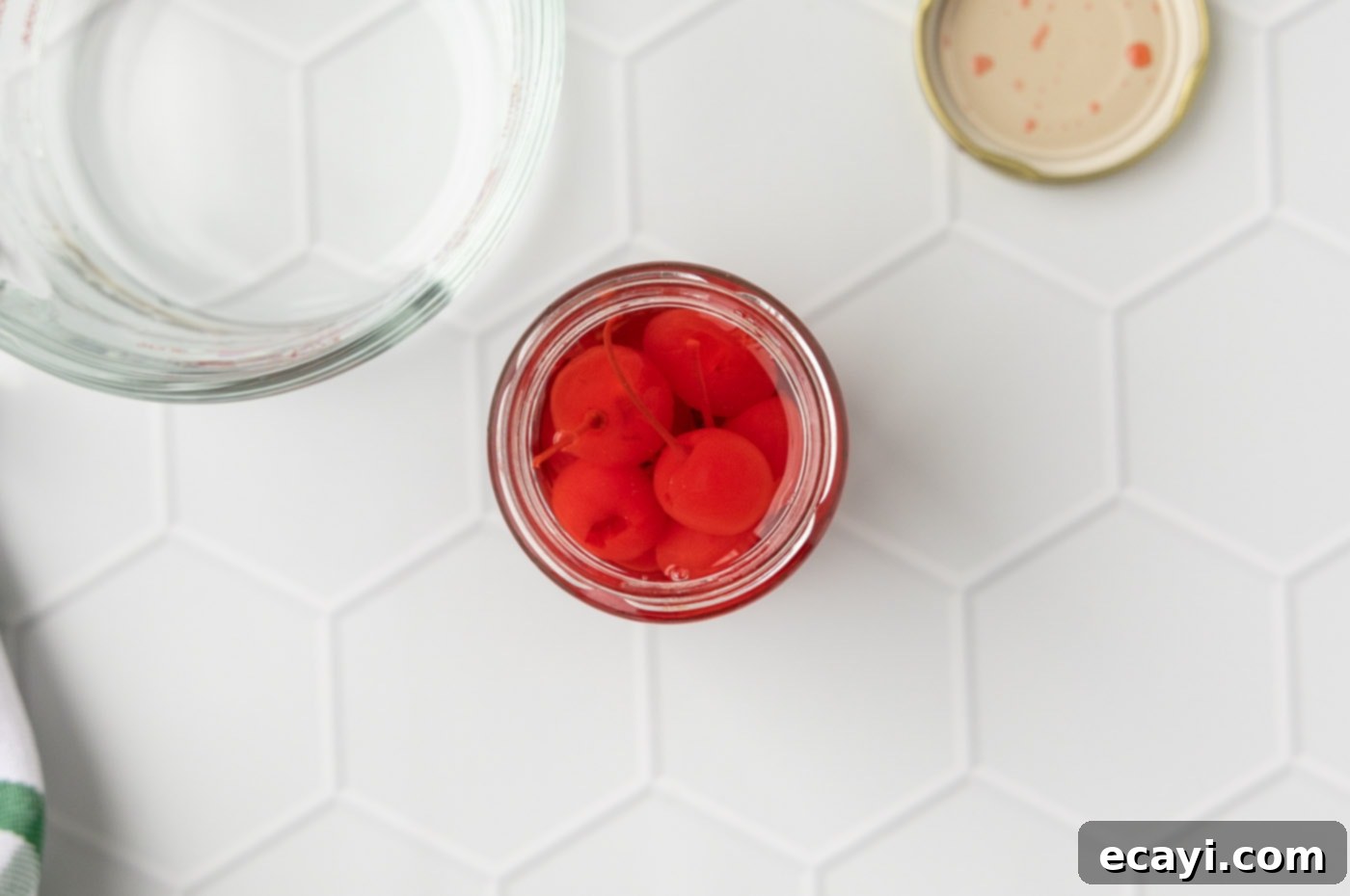 Crimson Edge 6 Maraschino cherries soaking in vanilla vodka within their jar, infusing.