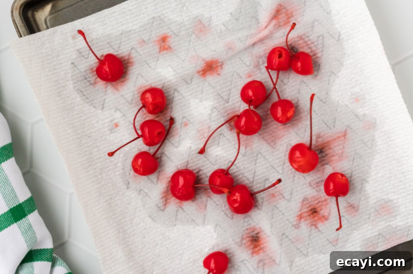 Crimson Edge 7 Vodka-infused cherries drying on paper towels before being dipped in chocolate.