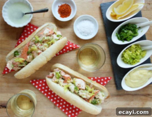 The Best Lobster Rolls Ever (yes, really!) Two beautifully presented perfect lobster rolls, garnished with fresh herbs, ready to be enjoyed.
