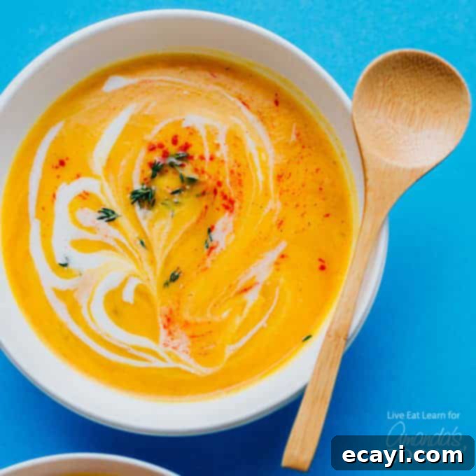 Slow Cooker Velvety Cauliflower Bliss 4 creamy cauliflower soup in a bowl with wooden spoon