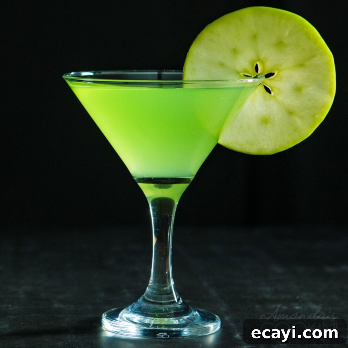 Single Appletini Cocktail A single, perfectly mixed Appletini in a martini glass on a dark background, showcasing its vibrant green color
