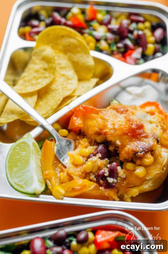 These easy to prepare stuffed pepper meal prep boxes are full of flavor and perfect for getting ahead of the game with your meals for the week! #mealprep #mealprepboxes #vegetarianmealprep #quinoa #stuffedpeppers #beansalad #lunch #dinner Close-up of delicious stuffed peppers meal prep boxes with bean salad