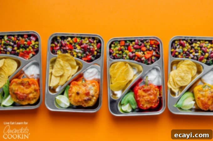 These easy to prepare stuffed pepper meal prep boxes are full of flavor and perfect for getting ahead of the game with your meals for the week! #mealprep #mealprepboxes #vegetarianmealprep #quinoa #stuffedpeppers #beansalad #lunch #dinner Stuffed peppers meal prep boxes neatly lined up