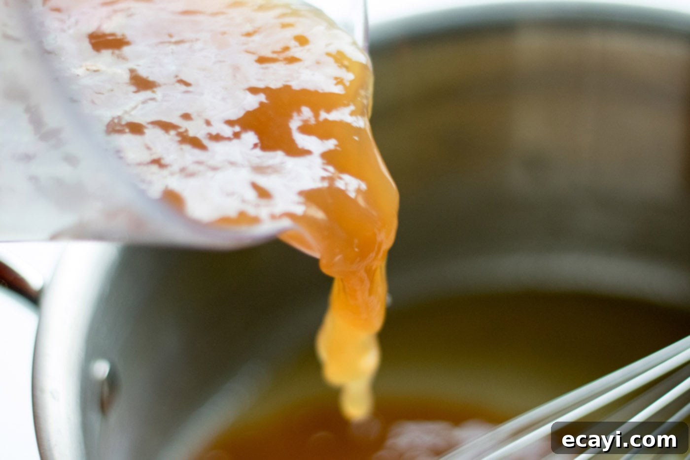 Perfect Turkey Gravy From Scratch 11 Pan drippings being added into a saucepan