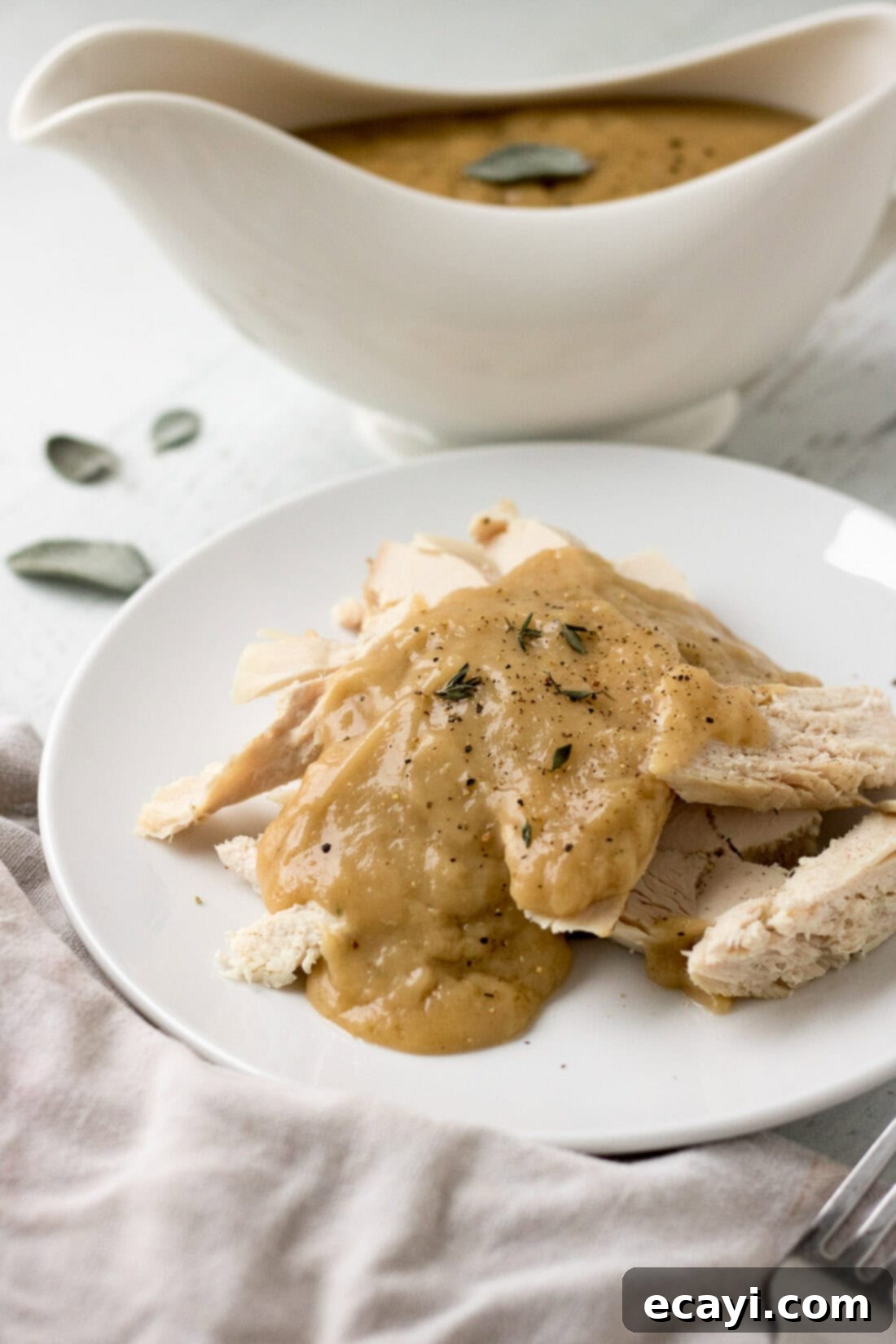 Perfect Turkey Gravy From Scratch 3 Homemade Turkey Gravy over sliced turkey on a plate