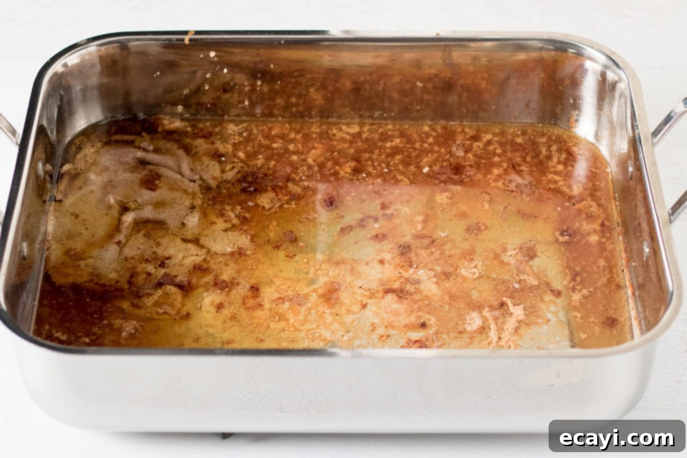 Perfect Turkey Gravy From Scratch 5 Roasting pan full of turkey drippings from roasting a turkey