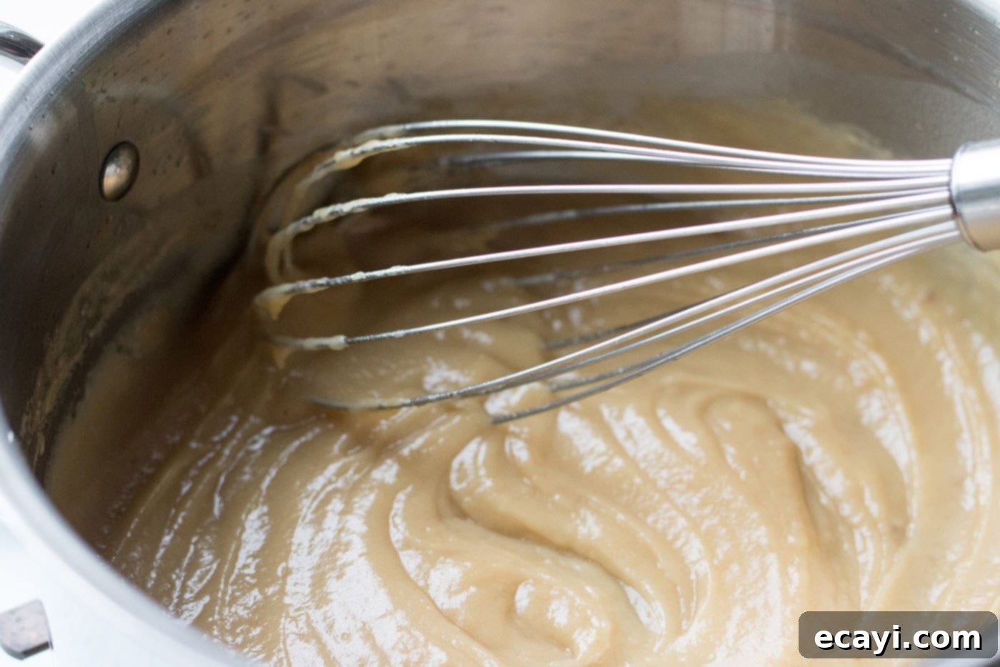 Perfect Turkey Gravy From Scratch 10 Whisk mixing a saucepan of fat and flour