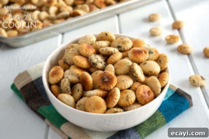 Serving ranch seasoned oyster crackers: A delicious bowl of crunchy, savory snacks, perfect for sharing at any gathering or enjoying on game day. #appetizers #appetizerrecipes #oystercrackers #superbowl #gamedayappetizers #gameday #crockpot #garlic #slowcooker #ranch #partyfood #partyappetizers A bowl filled with finished ranch seasoned oyster crackers, ready for serving