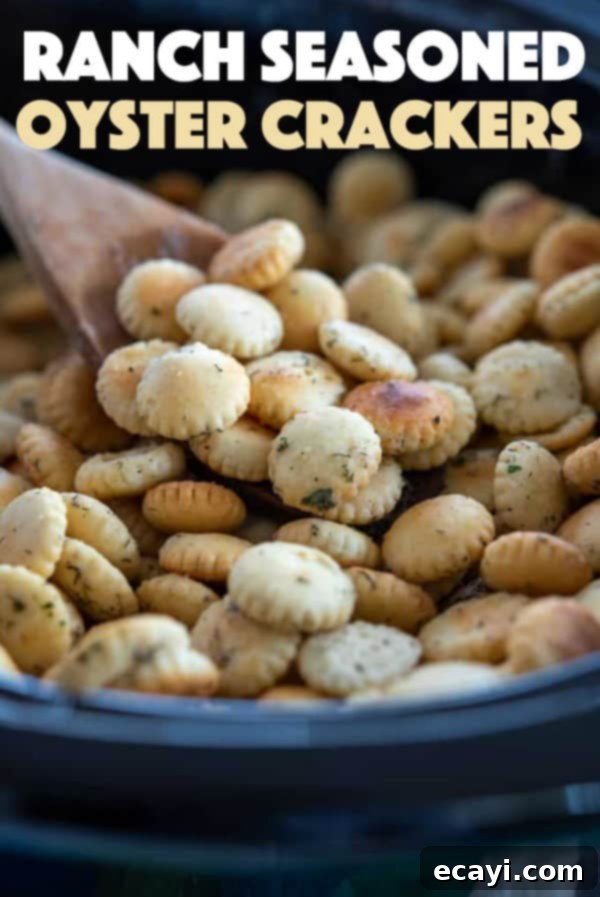 Finished ranch seasoned oyster crackers: A generous serving of crispy, flavorful snacks, perfect for any gathering or simply for personal enjoyment. #appetizers #appetizerrecipes #oystercrackers #superbowl #gamedayappetizers #gameday #crockpot #garlic #slowcooker #ranch #partyfood #partyappetizers A large bowl of delicious, golden brown ranch seasoned oyster crackers ready to be enjoyed.