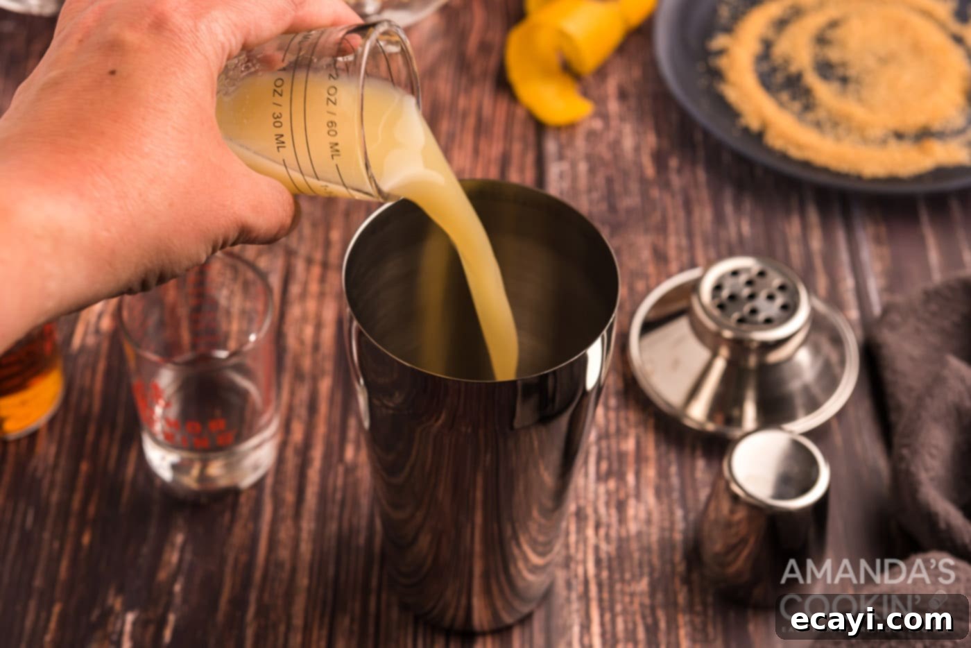 Sidecar: Tangy Elegance 6 Pouring fresh lemon juice into a cocktail shaker, illustrating the liquid ingredients for a Sidecar.