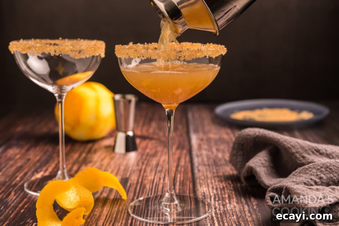 Sidecar: Tangy Elegance 7 Pouring a freshly shaken Sidecar cocktail into a coupe glass, showcasing the final step of preparation.