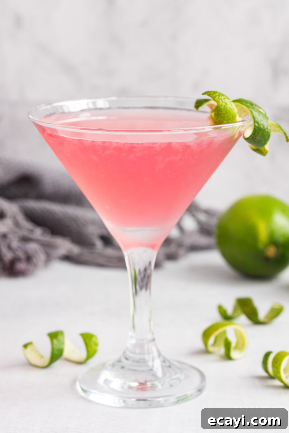 The Iconic Cosmopolitan Cocktail 2 Classic Cosmopolitan Cocktail served in a martini glass with a lime garnish