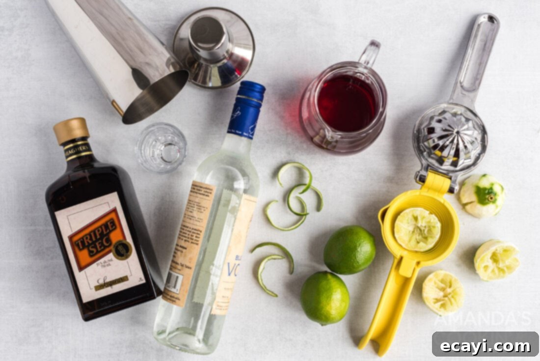 The Iconic Cosmopolitan Cocktail 4 Ingredients laid out for making a classic Cosmopolitan cocktail: citron vodka, Cointreau, cranberry juice, fresh limes.