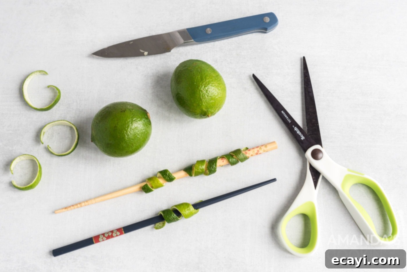 The Iconic Cosmopolitan Cocktail 5 Steps for creating a lime twist garnish: scissors, fresh lime, and a chopstick