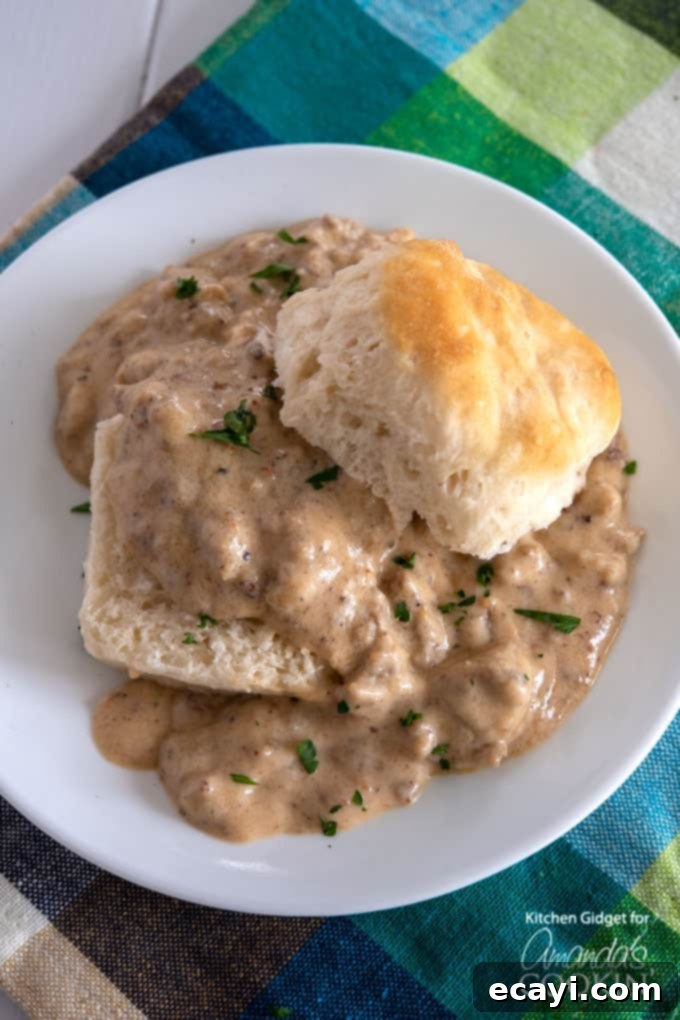 Hearty Country Gravy 2 Sausage gravy served over warm, fluffy biscuits, ready for a hearty breakfast