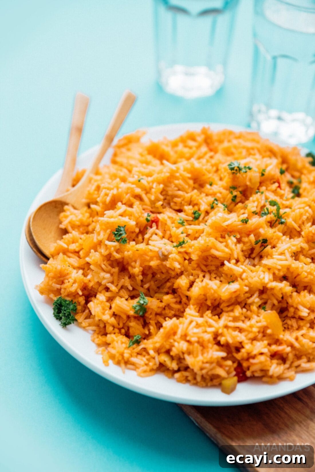 This Spanish rice recipe is a classic for good reason. A flavorful combination of onion, garlic, and salsa makes a side dish everyone loves. #mexican #spanishrice #dinnersides #sidedishes #vegetarian  A vibrant plate of fluffy Classic Spanish Rice, garnished with fresh cilantro, ready to be served.