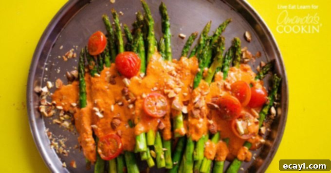 Roasted Asparagus with Smoky Romesco Sauce This Roasted Asparagus side dish is covered in delicious and healthy Smoky Romesco Sauce, cherry tomatoes, and crunchy chopped almonds. So good!