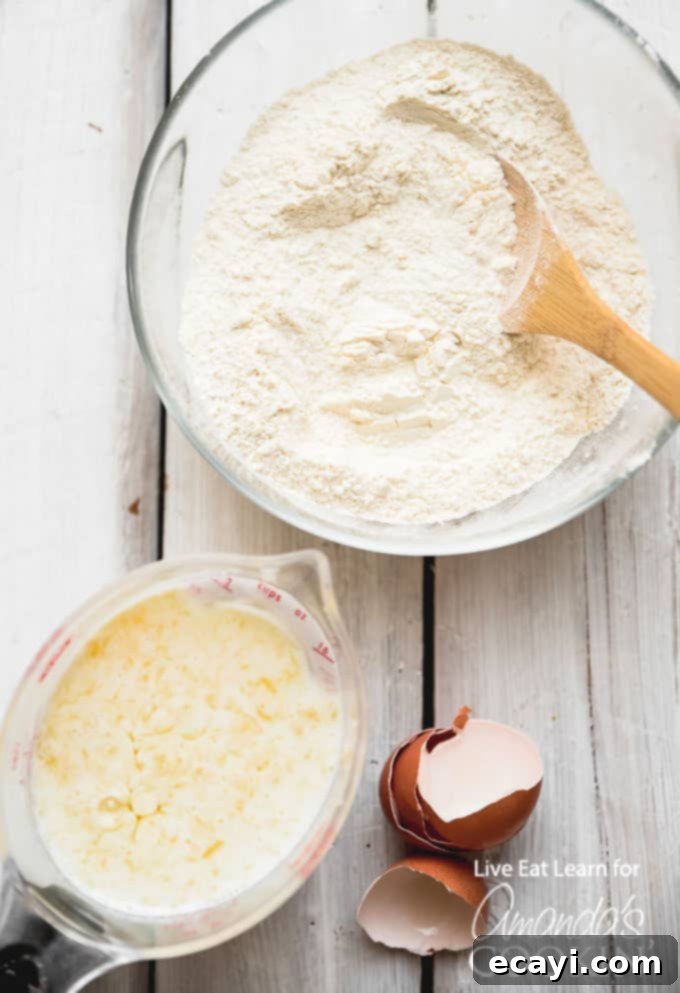 These classic buttermilk pancakes are fluffy, filling, and so delicious. Homemade pancakes are easier than you thought, so throw away that box mix! #breakfast #breakfastrecipes #buttermilkpancakes #pancakes #homemadepancakes Ingredients for making homemade buttermilk pancakes laid out on a kitchen counter.