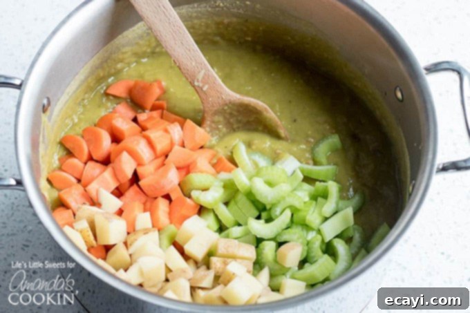 Fresh vegetables simmering for a delicious and nutritious Split Pea Soup with Ham. Fresh vegetables being added to a stock pot, preparing for a wholesome split pea soup