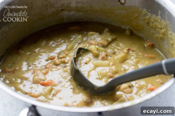 Hearty Split Pea Soup simmering to perfection in a large pot. Split pea soup simmering in a large stock pot on the stove