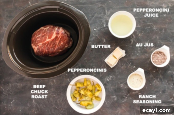 Effortless Southern Pot Roast Magic 2 Assortment of ingredients laid out: beef chuck roast, ranch seasoning packet, au jus gravy packet, butter, and a jar of pepperoncini peppers.