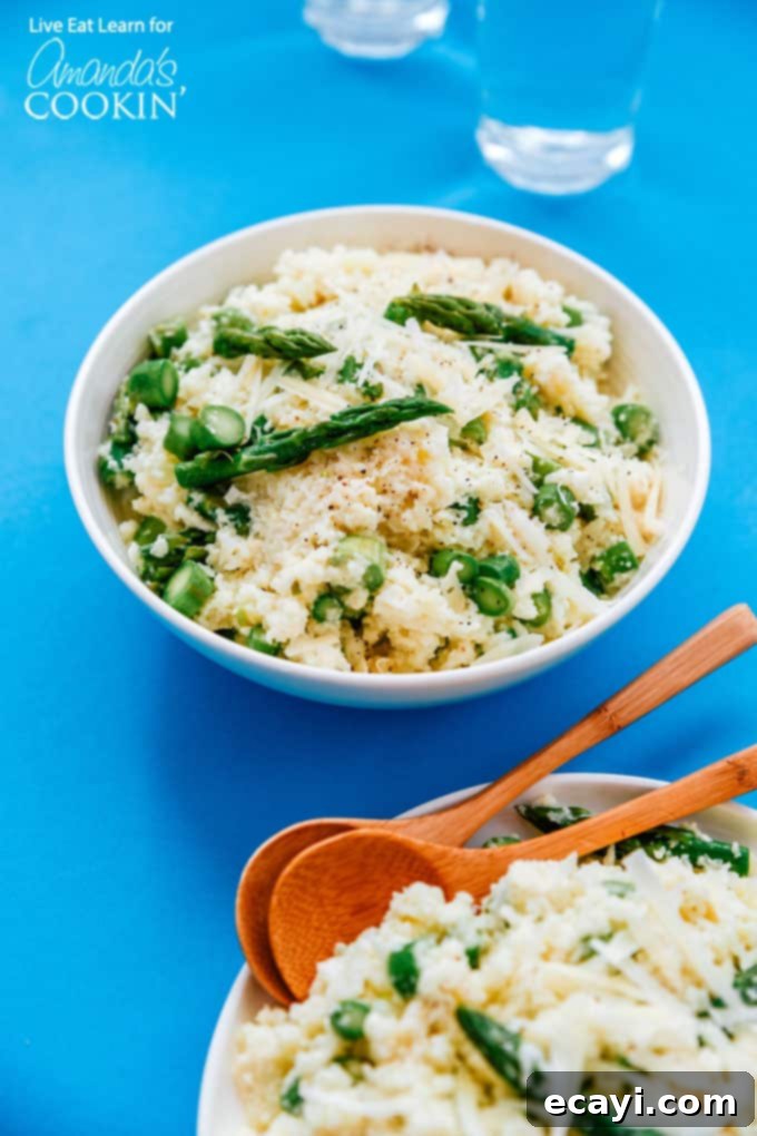 Creamy, Low-Carb Cauliflower Risotto with Asparagus – An Easy, Healthy, and Guilt-Free Dinner Idea. #risotto #lowcarb #asparagus #cauliflowerrice #cauliflowerrecipes #dinnerrecipes #garlic Creamy cauliflower risotto with vibrant green asparagus spears on top, served in a white bowl with a fork, emphasizing its delicious and healthy appeal.