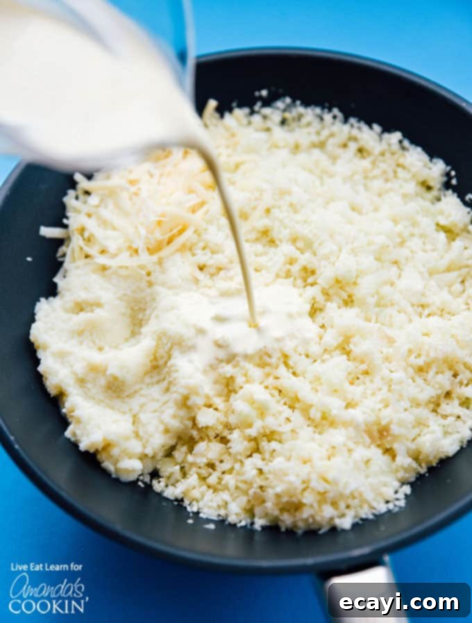 Simple Steps to Make Low-Carb Cauliflower Risotto Creamy and Delicious. #risotto #lowcarb #asparagus #cauliflowerrice #cauliflowerrecipes #dinnerrecipes #garlic A visual guide demonstrating how to prepare creamy cauliflower risotto in a pan, highlighting the cooking and stirring process for a perfect texture.
