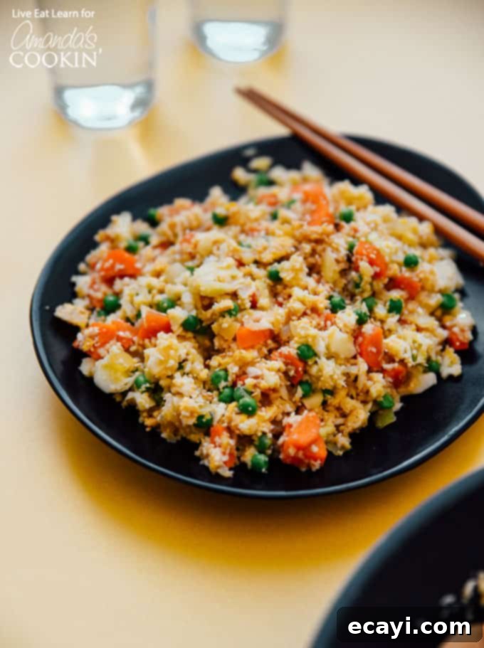 This Cauliflower Fried Rice is a delicious, low carb alternative to traditional fried rice. Keto friendly and super easy to make! #friedrice #keto #lowcarb #cauliflower #cauliflowerrecipes #cauliflowerrice #dinnersides #healthy #healthysides Cauliflower Fried Rice
