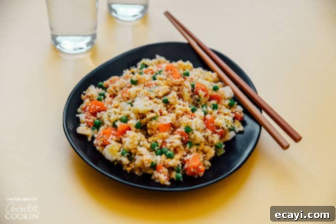 This Cauliflower Fried Rice is a delicious, low carb alternative to traditional fried rice. Keto friendly and super easy to make! #friedrice #keto #lowcarb #cauliflower #cauliflowerrecipes #cauliflowerrice #dinnersides #healthy #healthysides Cauliflower Fried Rice