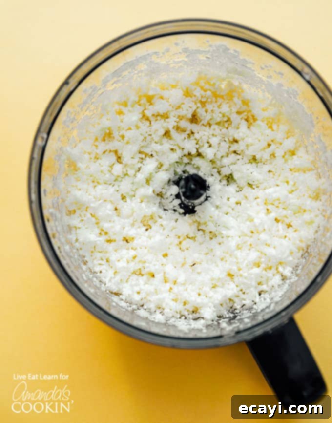 This Cauliflower Fried Rice is a delicious, low carb alternative to traditional fried rice. Keto friendly and super easy to make! #friedrice #keto #lowcarb #cauliflower #cauliflowerrecipes #cauliflowerrice #dinnersides #healthy #healthysides cauliflower in food processor