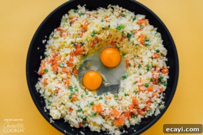 This Cauliflower Fried Rice is a delicious, low carb alternative to traditional fried rice. Keto friendly and super easy to make! #friedrice #keto #lowcarb #cauliflower #cauliflowerrecipes #cauliflowerrice #dinnersides #healthy #healthysides Cauliflower fried rice with egg