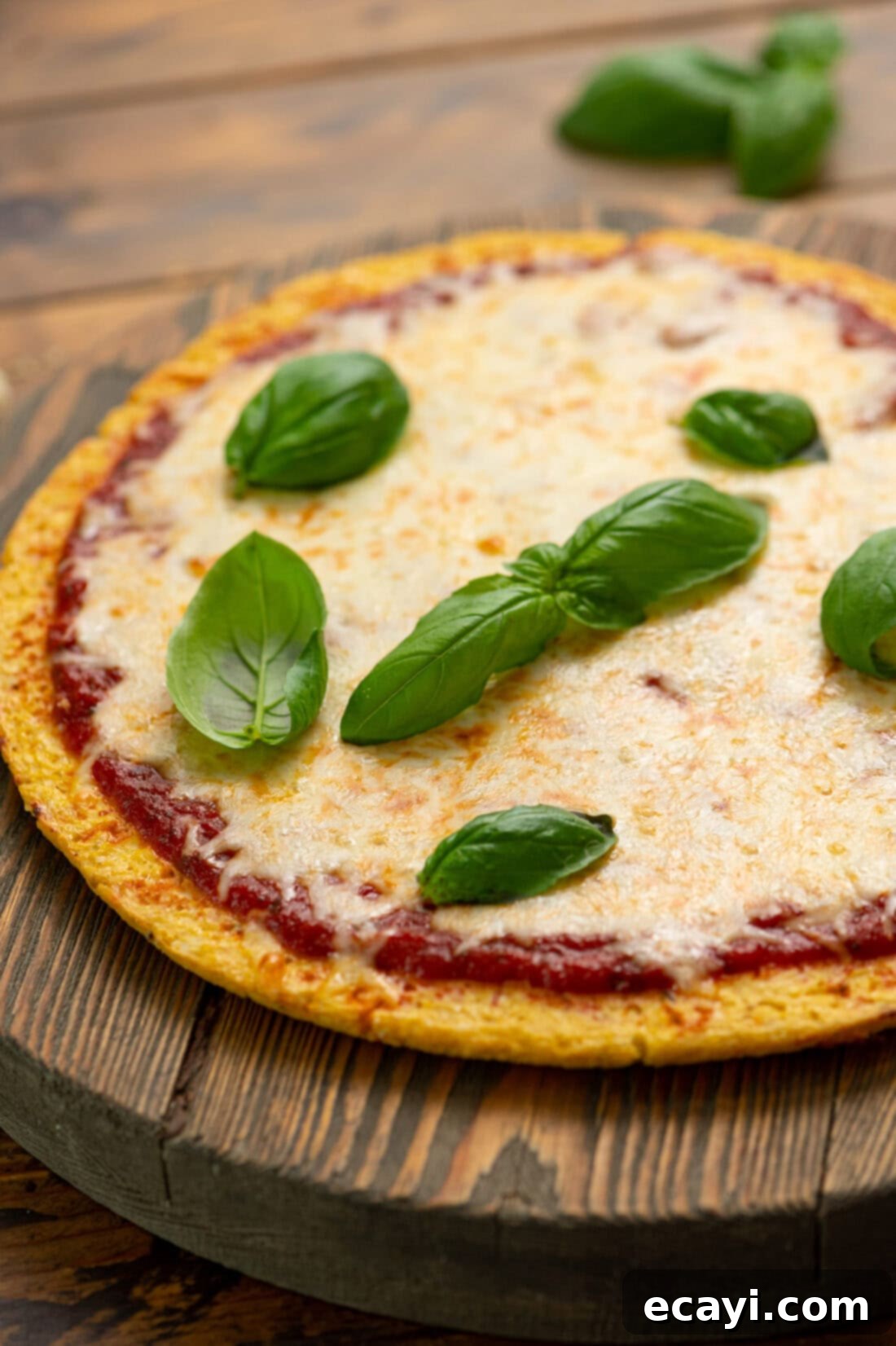 Cauliflower Power Crust 2 Close up photo of a perfectly baked Cauliflower Pizza Crust, golden brown and ready for toppings, showcasing its sturdy texture and cheesy appeal.