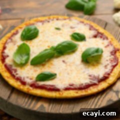 Cauliflower Power Crust 7 A delicious cauliflower pizza crust pizza with various toppings resting on a rustic wooden board, ready to be enjoyed.