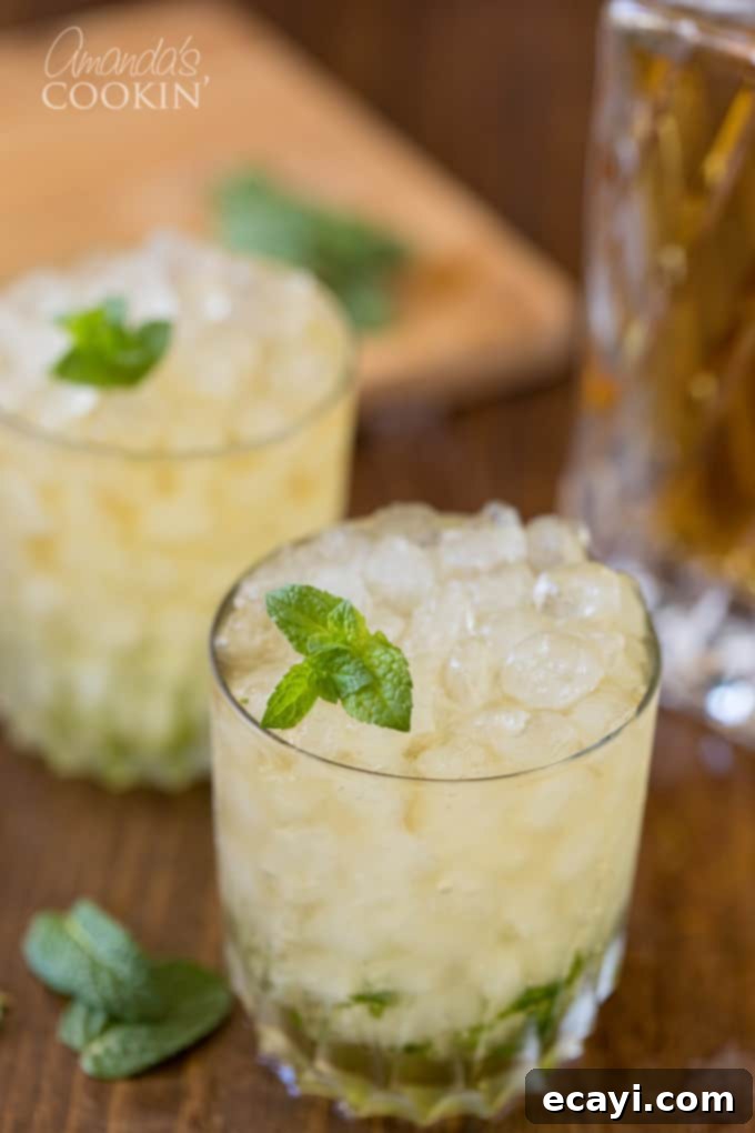 The classic Mint Julep, signature drink of the Kentucky Derby, is made with bourbon whiskey and served in a highball glass or a silver julep cup. Learn this easy cocktail recipe for your next gathering. Two perfectly crafted Mint Juleps in silver cups, ready for a celebratory toast.