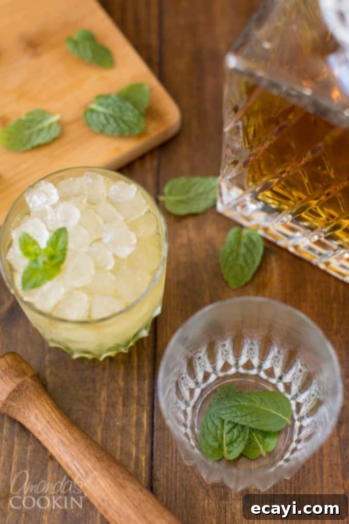 The classic Mint Julep, signature drink of the Kentucky Derby, is made with bourbon whiskey and served in a highball glass or a silver julep cup. Follow this easy cocktail recipe for a refreshing drink. Fresh mint leaves and simple syrup in a highball glass, ready for muddling.