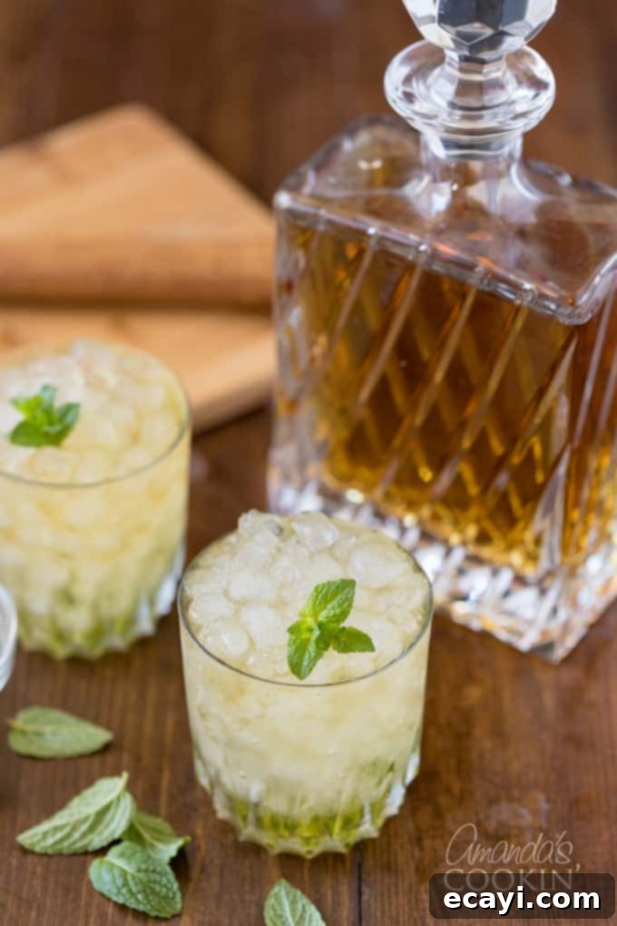 The classic Mint Julep, signature drink of the Kentucky Derby, is made with bourbon whiskey and served in a highball glass or a silver julep cup. Explore this cocktail recipe and other bourbon drinks. Bourbon whiskey in a crystal bottle, flanked by two glasses of Mint Julep, representing quality and tradition.
