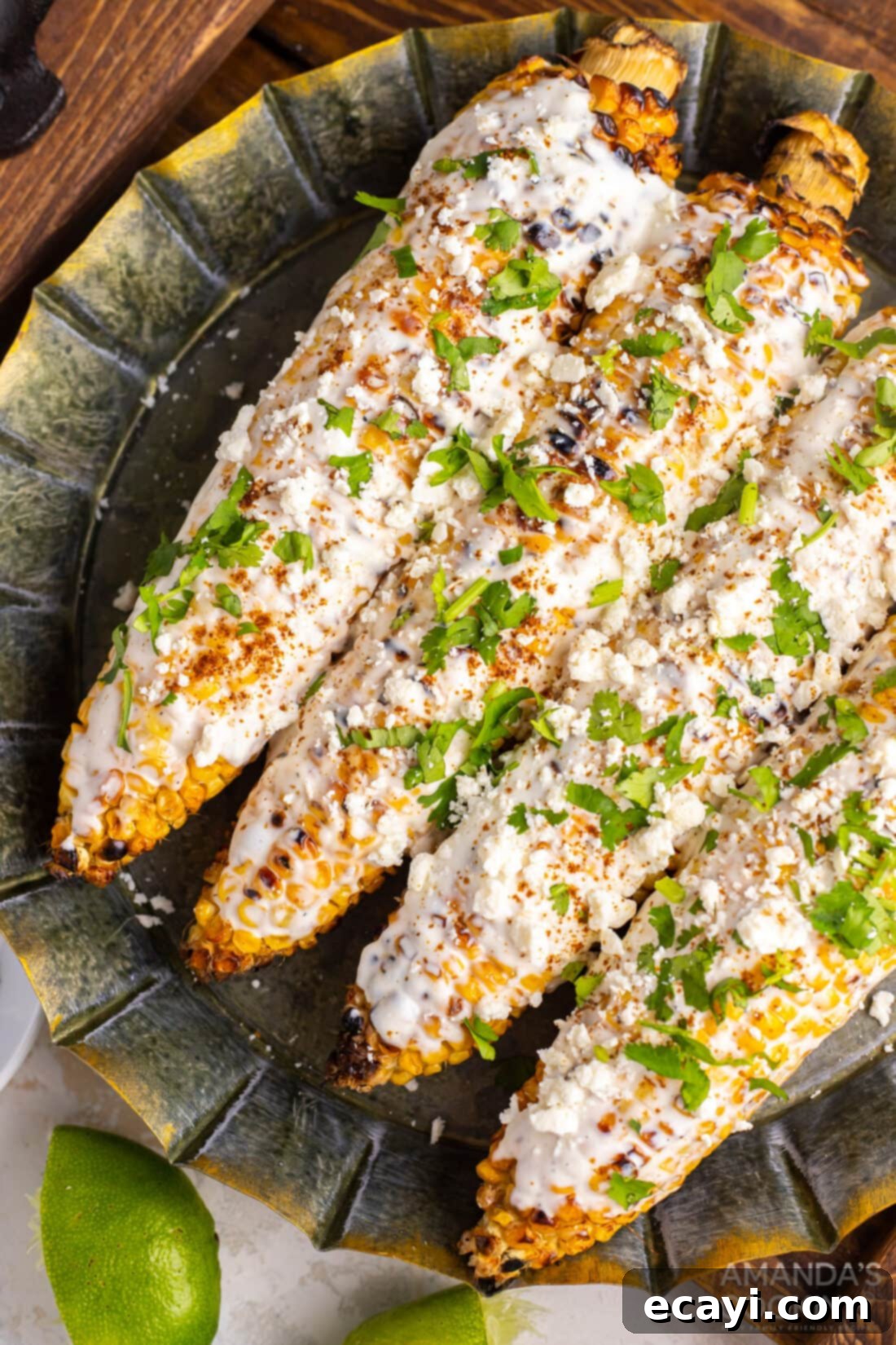 Savor the taste of summer with this delicious Mexican Corn on the cob, topped with cotija cheese, mayonnaise, and a blend of Latin spices. This easy recipe brings the best of Mexican street food to your backyard BBQ or any meal! #mexicanfood #elotes #cornonthecob #summerrecipes #grill plate of mexican street corn