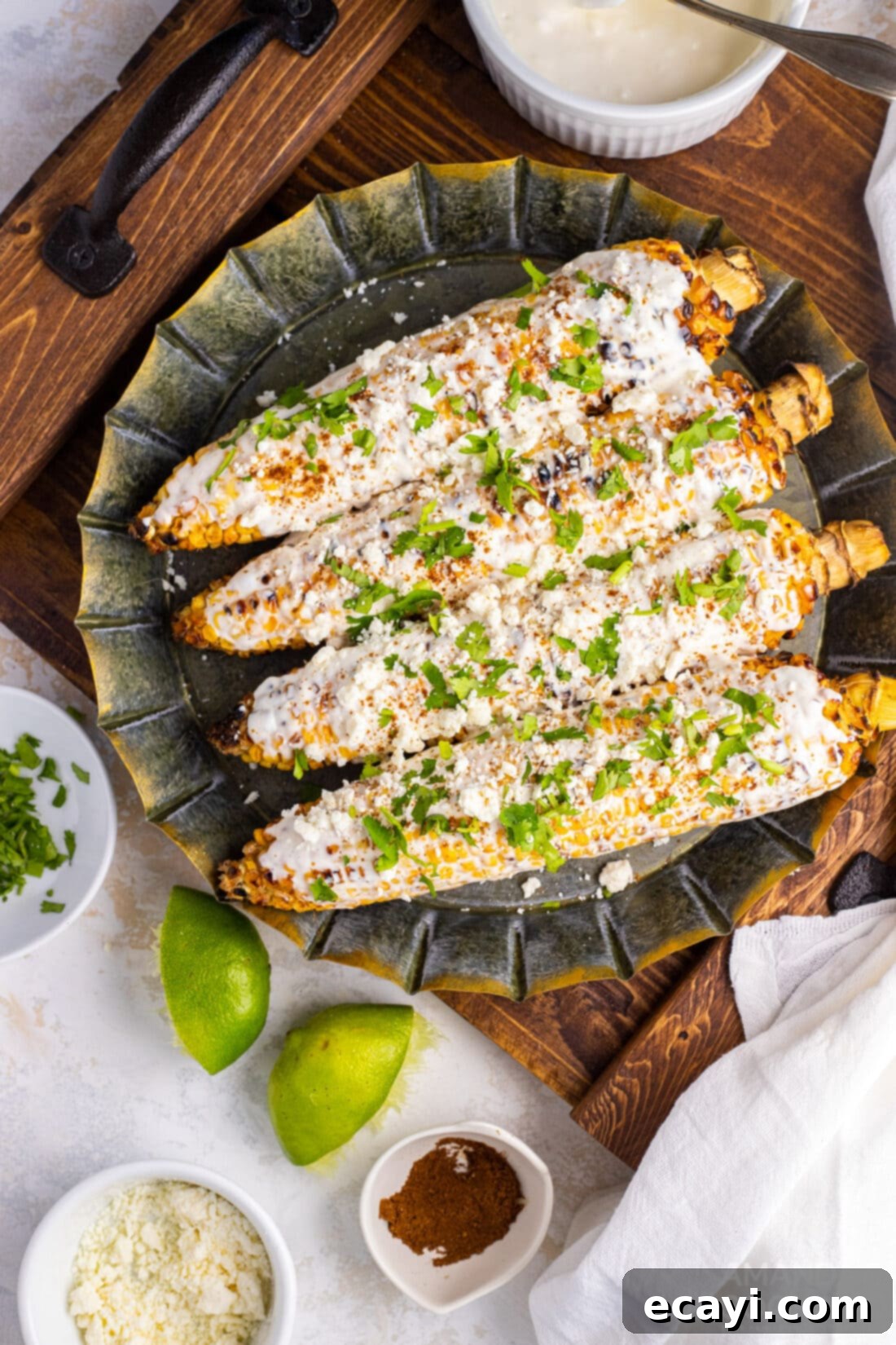 Transform your summer meals with this easy Mexican Corn recipe, featuring creamy mayo, salty cheese, and zesty Latin spices. Perfect for grilling or boiling, it's a flavorful Mexican street food you can enjoy anytime! #elotes #mexicanstreetcorn #bbqside #easyrecipes #corn mexican street corn on a plate