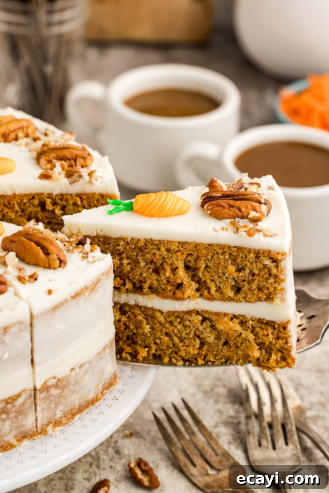Spiced Carrot Delight 2 A delectable slice of moist carrot cake being carefully removed from the two-tiered cake, showcasing its rich layers and creamy frosting.