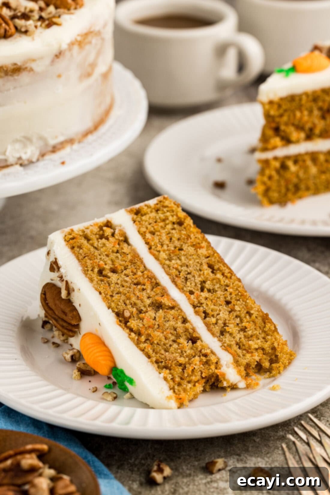 Spiced Carrot Delight 15 A perfectly portioned slice of moist carrot cake adorned with cream cheese frosting, pecans, and piped carrots, resting on a white plate ready to be enjoyed.