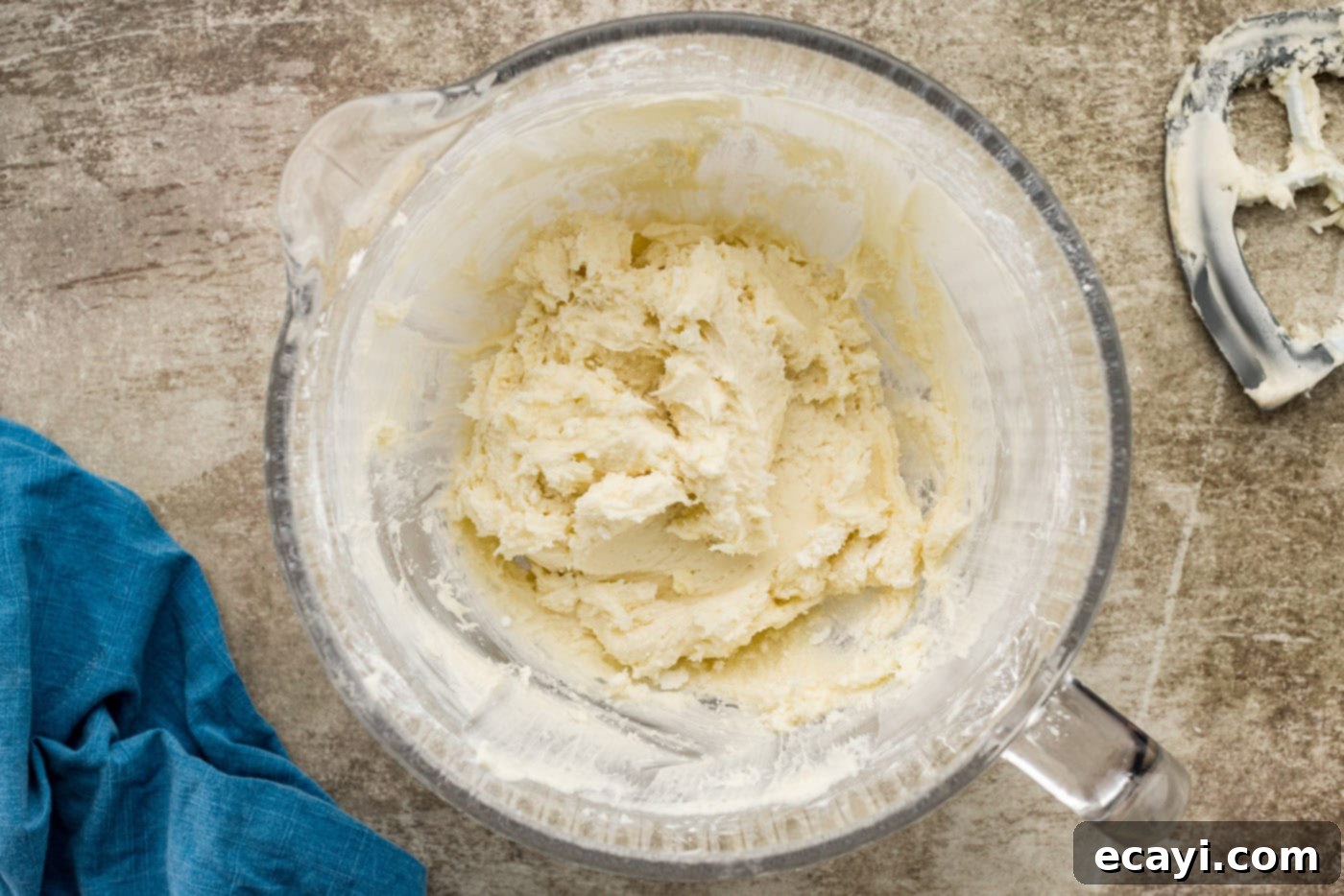 Spiced Carrot Delight 8 Fluffy cream cheese frosting, smooth and ready to be used, in a large mixing bowl.